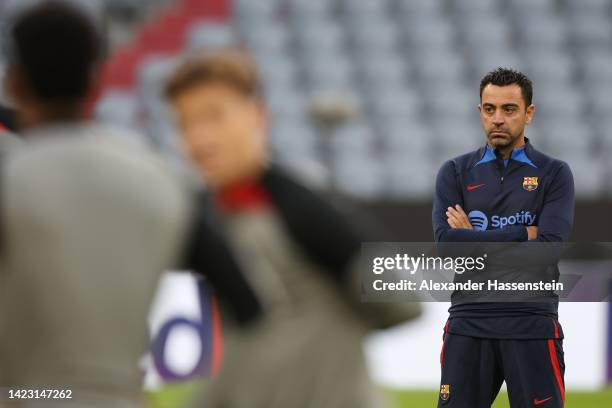 Xavi, head coach of FC Barcelona looks on during a FC Barcelona training session ahead of their UEFA Champions League group C match against FC Bayern...