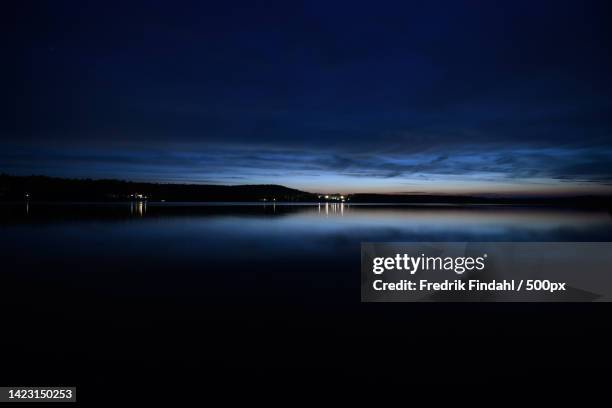 scenic view of lake against sky at night - väder stock pictures, royalty-free photos & images