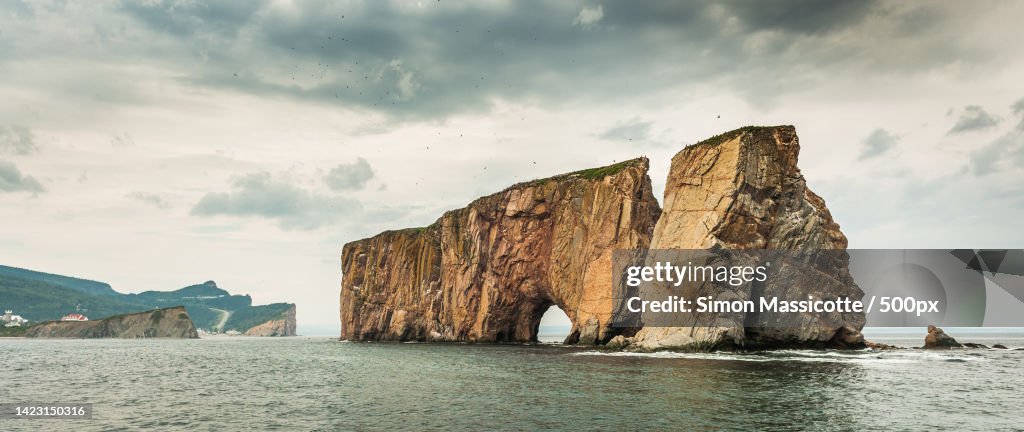Panoramic view of rock formation in sea against sky,Quebec,Canada