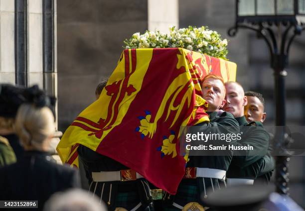 The coffin of Queen Elizabeth II is carried into St Giles Cathedral, after making its way along The Royal Mile on September 12, 2022 in Edinburgh,...