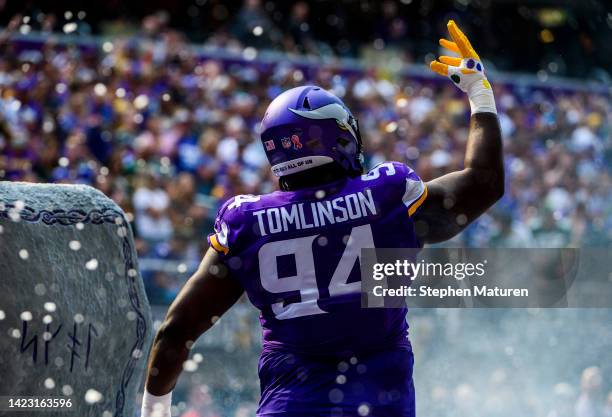 Dalvin Tomlinson of the Minnesota Vikings takes the field during player introductions before the game agains the Green Bay Packers at U.S. Bank...