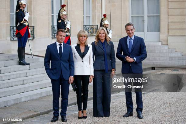 French President Emmanuel Macron and his wife Brigitte Macron pose with Greek Prime Minister Kyriakos Mitsotakis and his wife Mareva Grabowski prior...