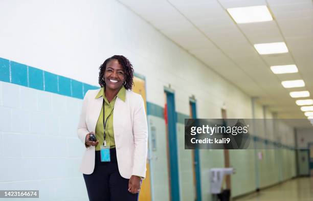 african-american female teacher in school hallway - school principal 個照片及圖片檔