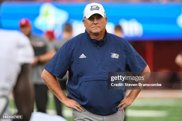 Head coach Clay Helton of the Georgia Southern Eagles watches the team warm up before the game against the Nebraska Cornhuskers at Memorial Stadium...