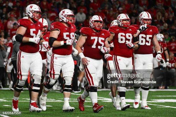 Offensive lineman Bryce Benhart of the Nebraska Cornhuskers and offensive lineman Henry Lutovsky and offensive lineman Trent Hixson and offensive...