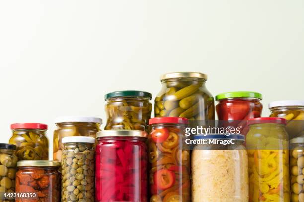 preserved vegetables, sauerkraut and pickled vegetables in glass jars - pickle jar stockfoto's en -beelden