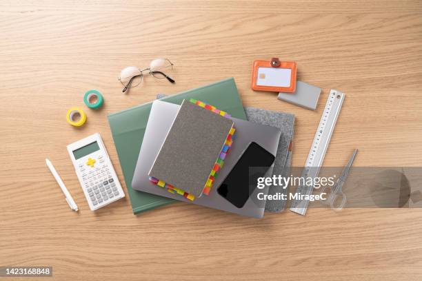 college school supplies with laptop and smart phone on desk - calculator top view stock-fotos und bilder