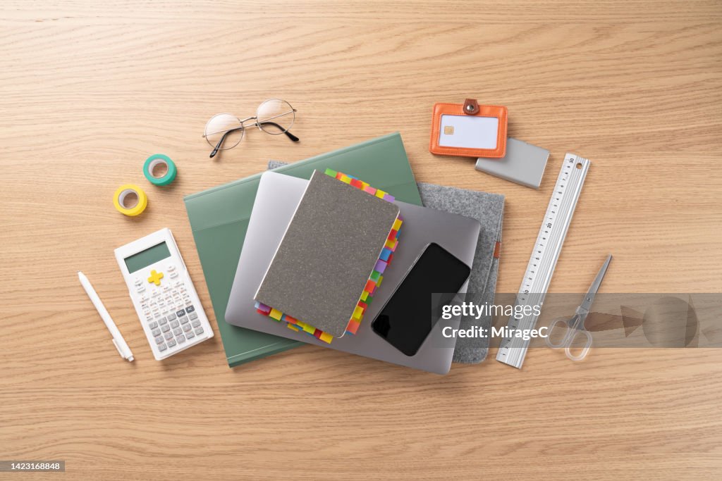 College School Supplies with Laptop and Smart Phone on Desk