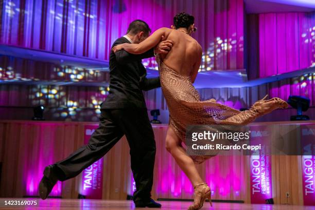 Stage Tango dancers make pirouettes as they take part in the competition during Buenos Aires International Tango Festival 2022 at Usina del Arte on...