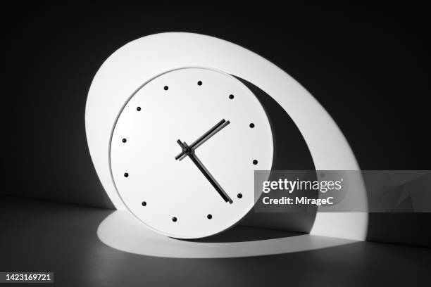 spot light focus on a clock in the dark - clock hand stock pictures, royalty-free photos & images