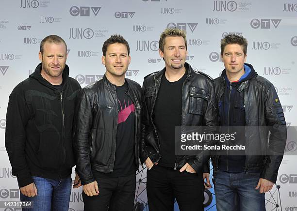 Mike Kroeger, Ryan Peake, Chad Kroeger, and Daniel Adair members of Nickelback poses on the red carpet at the 2012 JUNO Awards at Scotiabank Place on...