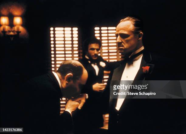 Italian actor Salvatore Corsitto kisses the hand of American actor Marlon Brando in a scene from the film 'The Godfather' , New York, New York, 1971....