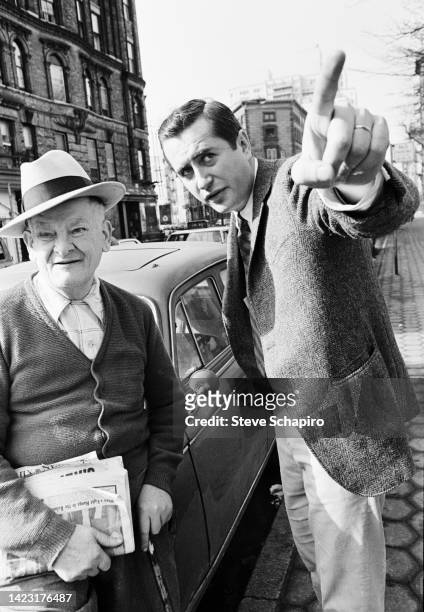 American film director and actor Robert Downey Sr points out something to an unidentified man on an unspecified street, New York, New York, 1967.