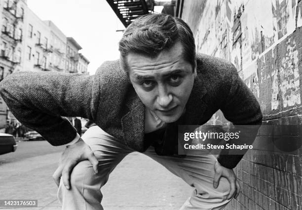 Portrait of American film director and actor Robert Downey Sr as he crouches, hands on his knees, on an unspecified street, New York, New York, 1967.