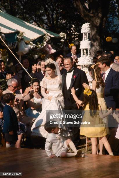 View of American actors Talia Shire and Marlon Brando as they walk arm in arm in a scene from the film 'The Godfather' , New York, 1971.