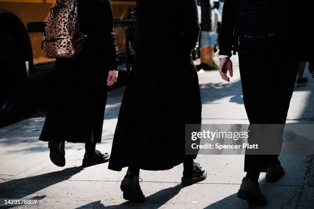 Orthodox Jewish children walk down a street outside of a yeshiva school in Borough Park on September 12, 2022 in the Brooklyn borough of New York...