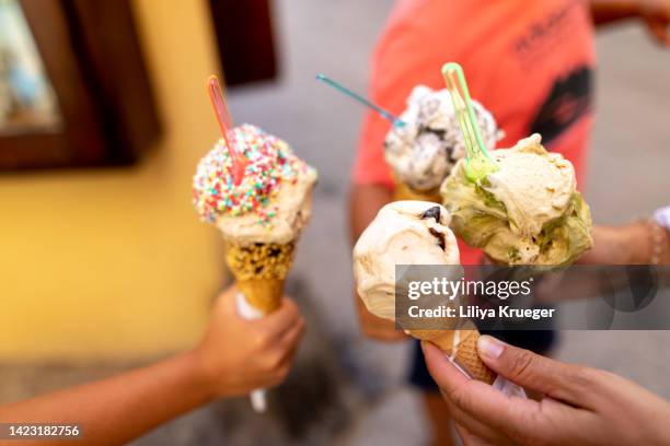 very appetizing ice cream in the hands of people. - freezing hands stockfoto's en -beelden