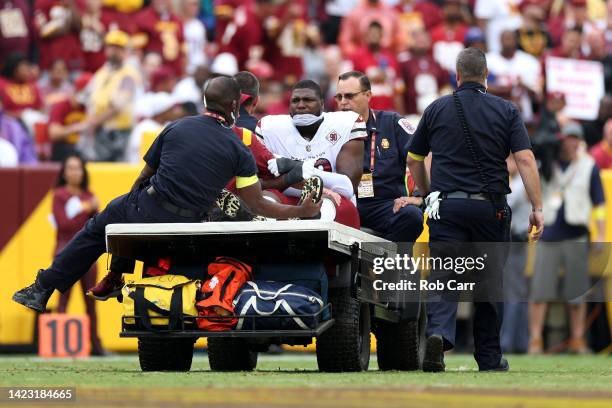 Defensive tackle Phidarian Mathis of the Washington Commanders is carted off the field after bing injured against the Jacksonville Jaguars at...