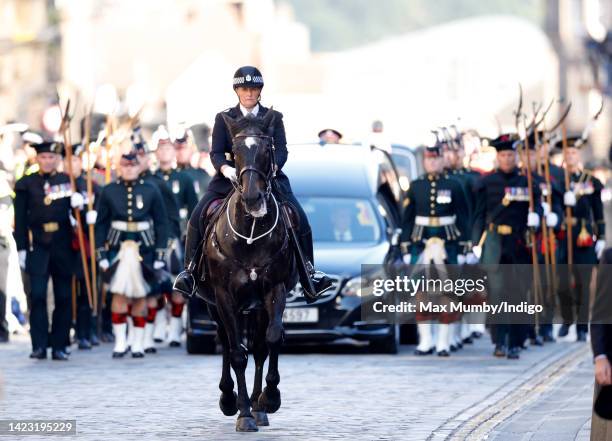 Mounted police officer leads a procession escorting Queen Elizabeth II's coffin along The Royal Mile to St Giles' Cathedral for a Service of...
