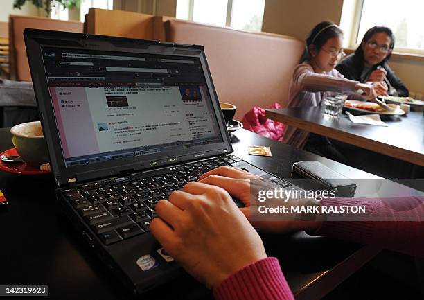 Woman views the Chinese social media website Weibo at a cafe in Beijing on April 2, 2012. China's move to shut down websites and curb rumours of a...