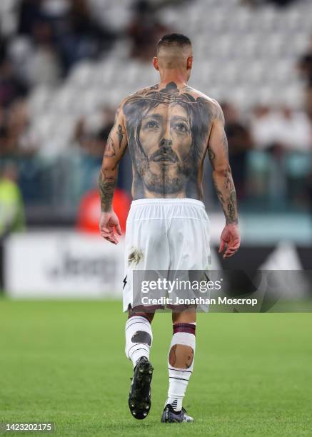 Tattoo of Jesus Christ is seen on the back of Pasquale Mazzocchi of Salernitana after removing his jersey following the final whistle of the Serie A...