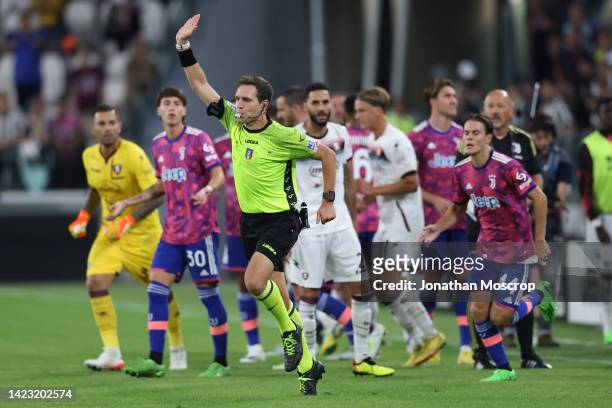 The Referee Matteo Marcenaro holds up his hand and blows his whistle to indicate offside and disallow Arkadiusz Milik of Juventus's late goal...