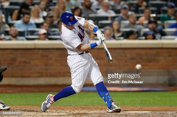 James McCann of the New York Mets connects on a fourth inning RBI base hit against the Chicago Cubs at Citi Field on September 12, 2022 in New York...