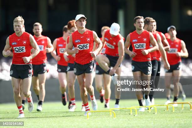 Swans players warm up during a Sydney Swans AFL training session at Sydney Cricket Ground on September 13, 2022 in Sydney, Australia.