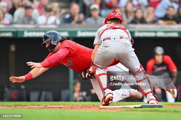 Austin Hedges of the Cleveland Guardians scores against catcher Max Stassi of the Los Angeles Angels in the second inning at Progressive Field on...