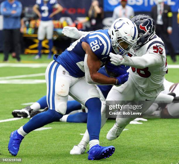 Indianapolis Colts running back Jonathan Taylor is tackled by Houston Texans linebacker Christian Kirksey during the second half at NRG Stadium on...