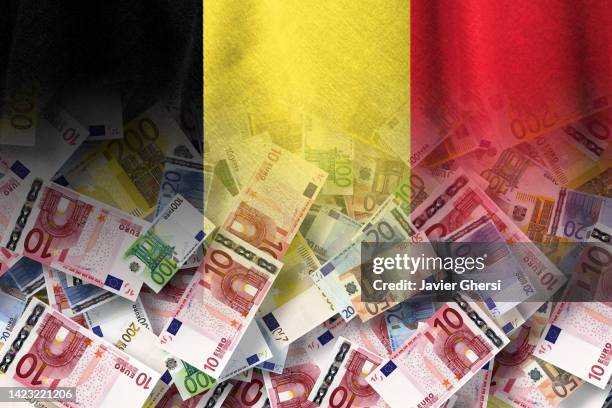 euro cash bills and belgium flag - belgië stockfoto's en -beelden