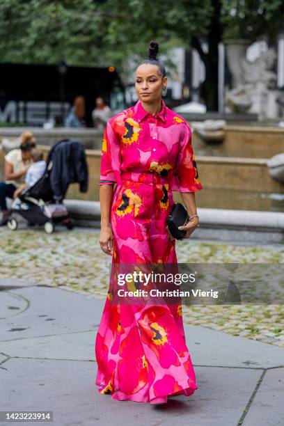 Sai De Silva wearing high waisted red pants with sunflower floral print, blouse outside Carolina Herrera on September 12, 2022 in New York City.