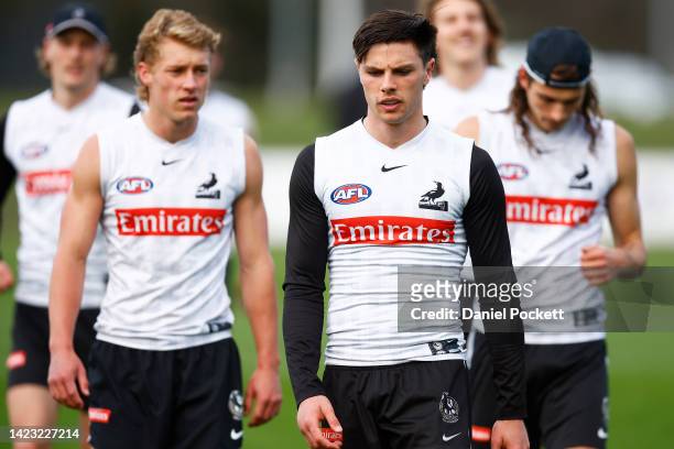 Oliver Henry of the Magpies and Finlay Macrae of the Magpies look on during a Collingwood Magpies AFL training session at Olympic Park Oval on...
