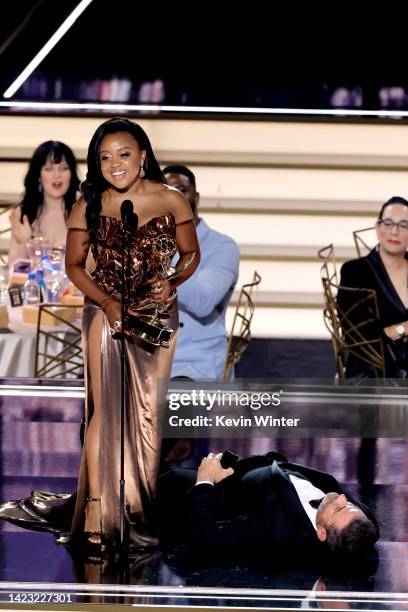 Quinta Brunson accepts Outstanding Writing for a Comedy Series for "Abbott Elementary" while Jimmy Kimmel lies onstage during the 74th Primetime...