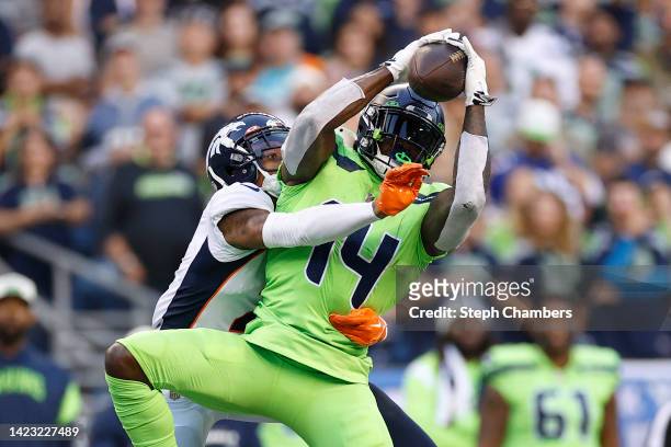 Metcalf of the Seattle Seahawks makes a reception over Pat Surtain II of the Denver Broncos during the third quarter at Lumen Field on September 12,...