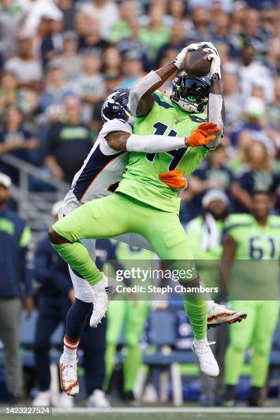 Metcalf of the Seattle Seahawks makes a reception over Pat Surtain II of the Denver Broncos during the third quarter at Lumen Field on September 12,...