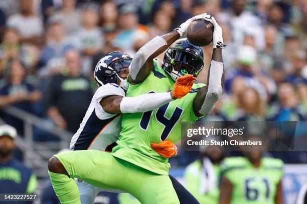 Metcalf of the Seattle Seahawks makes a reception over Pat Surtain II of the Denver Broncos during the third quarter at Lumen Field on September 12,...