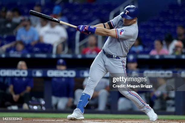 Nathaniel Lowe of the Texas Rangers singles during the first inning against the Miami Marlins during game one of a doubleheader at loanDepot park on...