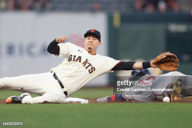 Ronald Acuna Jr. #13 of the Atlanta Braves steals second base ahead of the throw in the dirt to Wilmer Flores of the San Francisco Giants in the top...