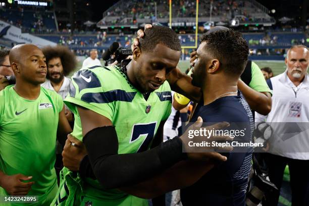 Geno Smith of the Seattle Seahawks and Russell Wilson of the Denver Broncos speak after the Seahawks defeated the Broncos 17-1 at Lumen Field on...