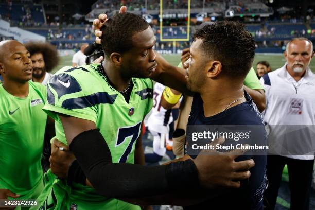 Geno Smith of the Seattle Seahawks and Russell Wilson of the Denver Broncos speak after the Seahawks defeated the Broncos 17-16 at Lumen Field on...