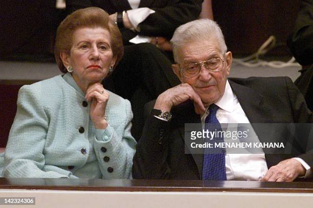 Israeli President Ezer Weizman sits with his wife Reuma 24 January 2000 at the Knesset in Jerusalem during a special session marking the 51st...