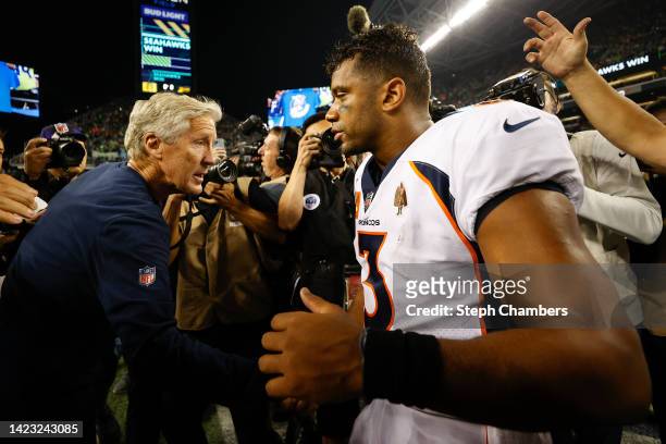 Head coach Pete Carroll of the Seattle Seahawks and Russell Wilson of the Denver Broncos shake hands after the Seahawks defeated the Broncos 17-16 at...