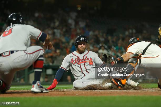Robbie Grossman of the Atlanta Braves scores against catcher Austin Wynns of the San Francisco Giants on a two-run single off the bat of Dansby...