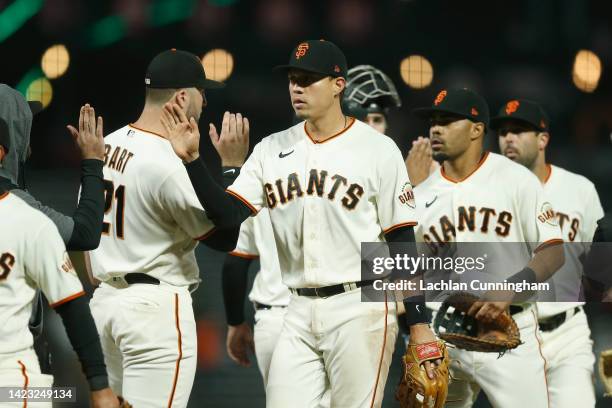 Wilmer Flores of the San Francisco Giants celebrates with teammates a 3-2 win against the Atlanta Braves at Oracle Park on September 12, 2022 in San...