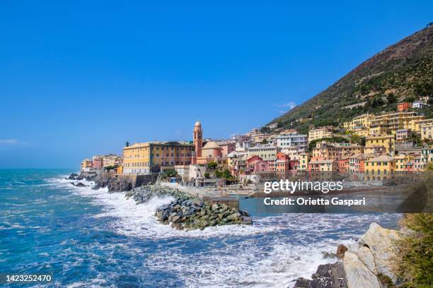 small harbor in nervi, genoa, bordered by colorful buildings - italy - genua stockfoto's en -beelden