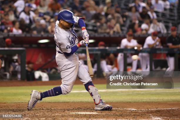 Mookie Betts of the Los Angeles Dodgers hits a three-run home run against the Arizona Diamondbacks during the ninth inning of the MLB game at Chase...