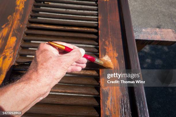 repairing an old wooden shutter - metal sanding stock-fotos und bilder