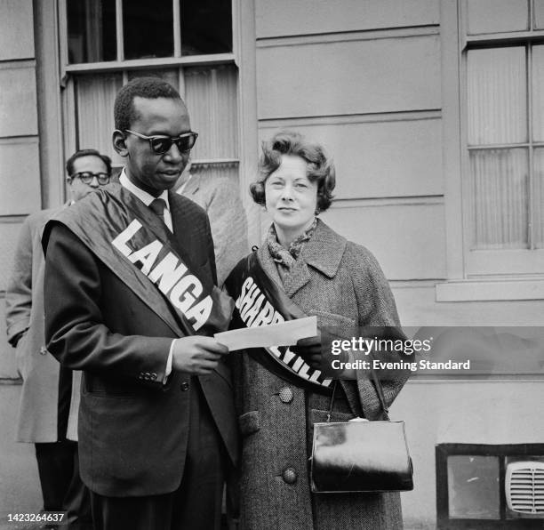 Tanzanian politician and anti-colonial activist Julius Nyerere , Prime Minister of Tanganyika, wearing a sash reading 'Langa,' and British politician...