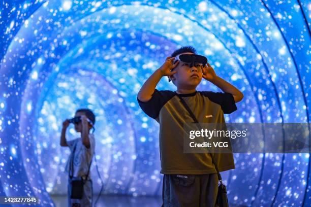 Children wearing AR glasses visit an insect amber exhibition at Shanxi Museum during the Mid-Autumn Festival holiday on September 12, 2022 in...